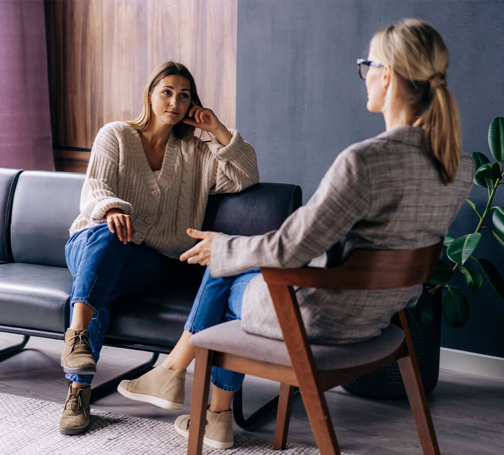 A young woman in a consultation with a professional psychologist listens to advice on improving behavior in life.