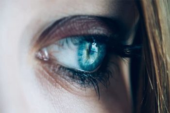 close up of woman's eye looking in the distance